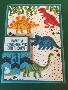 a card with dinosaurs and trees on it