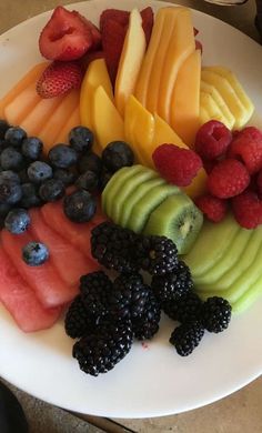 a white plate topped with cut up fruit