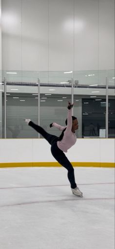 a female figure skating on an ice rink