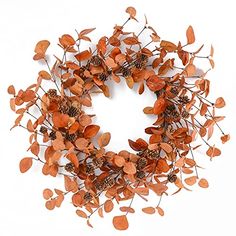 a wreath made out of leaves and pine cones