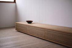 a bowl sitting on top of a wooden shelf