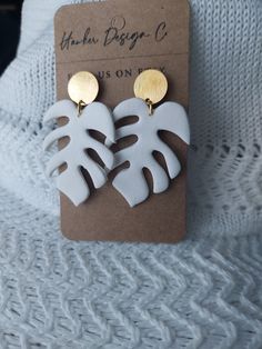 White monsters leaf polymer clay earrings by Hawker Design Co White Leaf-shaped Jewelry Gift, Trendy Handmade Leaf-shaped Earrings, Handmade White Leaf-shaped Jewelry, Unique White Polymer Clay Earrings, Handmade White Leaf-shaped Earrings, Handmade White Polymer Clay Jewelry, Hand Painted White Clay Jewelry, Everyday White Clay Jewelry, White Leaf-shaped Earrings With Ear Wire