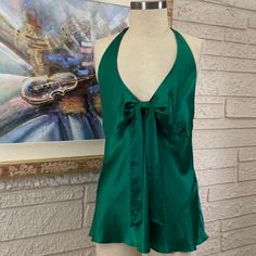 Measurements Are Approximate And Taken With Garment Laying Flat. 100% Silk Hand Wash Line Dry Charmeuse Silk Lined Bustline Halter Style Emerald Green V-Neckline Sash Front Invisible Side Zipper Closure Hook & Eye Closure Side Length 17” Armpit To Armpit 20” Elegant Green V-neck Camisole, Green Silk V-neck Top, Elegant Green Tank Top, Elegant Green Camisole Tank Top, Elegant Green Cami Tank Top, Green V-neck Tank Top For Night Out, Chic Green Camisole, Chic Green Tank Blouse, Chic Green Camisole Tops