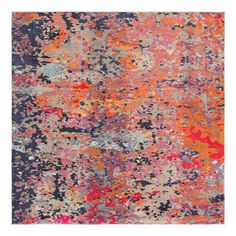 an orange, blue and pink rug with lots of different colored paint splattered on it