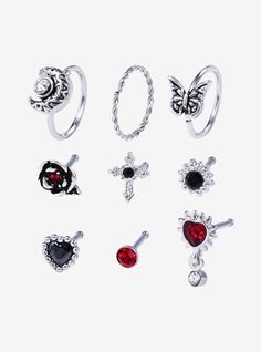 six pairs of rings with red and black stones on them, all in different styles