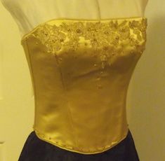 GOLD SILK COUTURE LACE  UP CORSET TOP  Size 10 Australian Couture Item, Original Design This beautifully handcrafted corset top has hand stitched gold guipure lace applique with gold glass beading. The edges of the bustier are piped with the same gold silk satin. The lower edge, back neckline and centre back edges have scatter glass beading. The lace up is gold silk satin matching the bustier fabric. The bustier is fully lined and interlined with boning in every seam and between seams to ensure Australian Wedding Dresses, Silk Corset, Top Bustier, Lace Corset Top, Floaty Dress, Duchess Satin, Guipure Lace, Gold Silk, Lace Corset