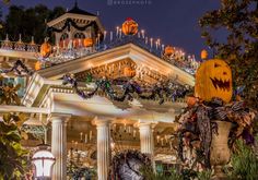 a house decorated for halloween with pumpkins and decorations