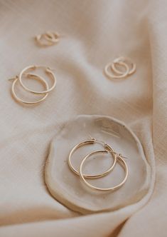 Giving big hoop energy. Our Bold Hoops are a thicker, bolder take on our fan-favorite Endless Hoops. Available in 14mm, 20mm, 28mm, and 35mm. Sold as a pair. Available in 14kt Gold Fill + Sterling Silver. Kayla pairs the hoops with our Lightening Bolt Studs. Jess pairs it with Tiny Hoops and Tiny Twist Earrings. Our jewelry is handmade so each piece will be unique and may vary slightly from what is pictured. Twist Earrings, Copper Uses, Adornment Jewelry, Everyday Wear Jewelry, Hoop Charms, Jewelry Cleaner, Jewelry Case, Be Unique, 14kt Gold