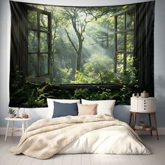 a bedroom with an open window and lush green forest scene on the wall behind it