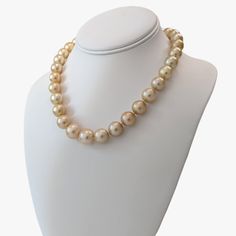 Indulge in the elegance and natural beauty of this stunning South Sea pearls necklace, featuring Golden South Sea pearls sourced from Indonesia. Crafted with meticulous attention to detail, this necklace is a testament to exceptional craftsmanship and exquisite materials.Secured with a 14K yellow gold 'twist and lock' clasp, the necklace measures 17.25 inches (43.5cm) in length, draping gracefully around the neckline. The weight of 95.7g adds a substantial feel and underscores the luxurious qual Luxury Pearl Necklaces With Round Beads, Luxury High Luster Pearl White Pearl Necklace, Luxury High Luster Pearl White Necklace, Luxury Pearl White Necklace With High Luster, Luxury High Luster Necklaces For Formal Occasions, Formal Akoya Pearl Necklace With High Luster, Luxury Pearl White Pearl Necklace For Formal Occasions, Luxury High Luster Akoya Pearl Necklace, Formal High Luster Akoya Pearl Necklace