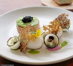 a white plate topped with different types of desserts on top of a wooden table