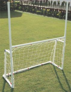 a white soccer goal with red balls on it