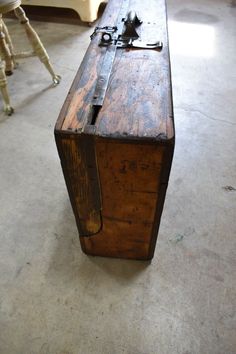 an old wooden box sitting on the floor