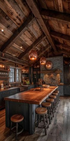 a large kitchen with wooden floors and lots of counter top space, along with bar stools