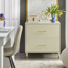 a white dresser sitting next to a window in a living room with a plant on top of it