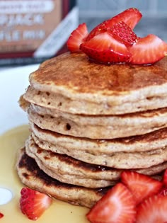 a stack of pancakes with strawberries on top