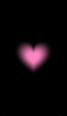 a pink heart on a black background