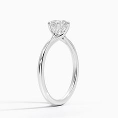 a white gold ring with a pear shaped diamond