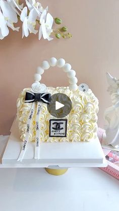 a white purse shaped cake sitting on top of a table