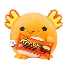 an orange stuffed animal holding a reese's candy bar