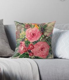 a painting of pink flowers on a gray couch with white throw pillow and clock in the background