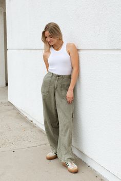 Introducing the Bridget Cargo Pants: These super cool barrel leg pants feature a relaxed fit for ultimate comfort and a vintage dye wash for a unique style. The cinched ankles and stretchy waist provide a perfect fit while the 5 pockets offer ample storage. Perfect with your favorite t-shirt and sneakers!Early Winter CapsuleFITEasy Relaxed FitMore Mid RiseBarrel LegVintage Garment DyeStretchy Back in Waist + AnklesZipper FlyKaylee is 5'3 Wearing Size SmallNatalia is 5'9 Wearing Size SmallSIZESMALLMEDIUMLARGELENGTH39" Long39.5" Long40" LongWIDTH (Across Waist)13" Wide14" Wide15" WideINSEAM30.5"30.5"30.5"RISE10"10.5"11"For more sizing information, please click HEREPAIRED WITHCruz Sweater TankMadison Waffle Long SleeveMATERIAL + CARE80% Cotton20% PolyesterHand Wash ColdDo Not BleachHang or Li Early Winter, Super Cool, Cargo Pants, Leg Pants, Casual Pants, Unique Style, Barrel, Perfect Fit, Relaxed Fit