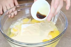 someone is mixing ingredients in a glass bowl