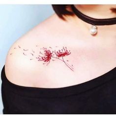 a woman's chest with a dandelion tattoo on her left side breast