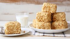 several pieces of oatmeal cookies on a plate next to a glass of milk