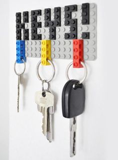 some lego key chains are hanging on the wall with keys attached to them and one is missing