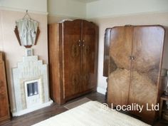 a bedroom with wooden furniture and a fireplace