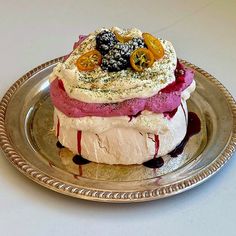 two layered desserts are on a silver plate