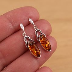 This is 925 Sterling Silver Earrings & Genuine Baltic Amber .     Approx. earrings measures:                total length: 31mm               drop length: 25 mm               width: 8 mm     Approx. weight: 3.1gr. Presented in gift box!