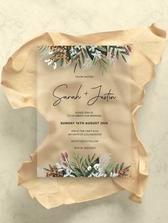 a wedding card with flowers and leaves on it