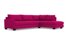 a pink sectional couch with wooden legs