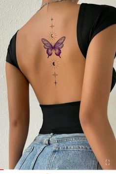 the back of a woman's body with a butterfly tattoo on her left side