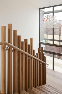 a wooden stair case in front of a window