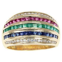 A Five Row Diamond, Blue Sapphire, Emerald, Ruby Invisibly Set Cocktail Ring made in 18 Karat Yellow Gold. The ring size is US 6.25. The total weight of the ring is 6.60 grams. Multicolor Brilliant Cut Sapphire Ring For Formal Occasions, Multicolor Sapphire Ring With Prong Setting For Formal Occasions, Formal Multicolor Sapphire Ring With Prong Setting, Multicolor Elegant Diamond Ring For Formal Occasions, Elegant Multicolor Diamond Ring For Formal Occasions, Multicolor Baguette Cut Fine Jewelry Rings, Formal Multicolor Brilliant Cut Rings, Multicolor Hallmarked Fine Jewelry Rings, Multicolor Multi-stone Baguette Cut Rings