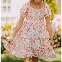 The Mary Anne Dress Is A Floral, Tiered Mini Dress Featuring A Smocked Top And Cuffed Sleeves. Spring Smock Dress With Square Neck, Spring Smocked Dress With Square Neck For Summer, Spring Summer Smocked Dress With Square Neck, Spring And Summer Smocked Dress With Square Neck, Red Smocked Dress For Vacation In Spring, Red Smocked Dress For Spring Vacation, Spring Vacation Red Smocked Dress, Square Neck Smocked Mini Dress For Brunch, Fitted Smock Floral Dress For Spring