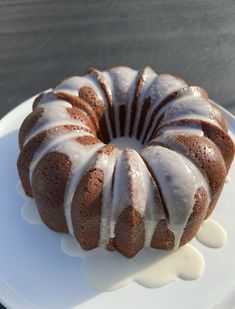 a bundt cake with icing on a white plate