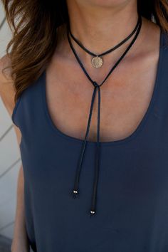 The Leather Wrap Choker/Lariat Tie is a fun and versatile necklace! Wear as choker or lariat tie. Choose either a sterling silver or 14K gold filled 5/8 hammered or blank disc to compliment the black or brown genuine leather wrap. *CHOOSE between a hammered or blank disc ...........and....... BLACK or BROWN leather  - premium 16mm (5/8)14k Gold Filled or Sterling Silver - signature hammered finish on the disc - 47 genuine leather wrap with gold or silver bead at each end - each... Festival Lariat Jewelry With Adjustable Cord, Gold Jewelry With Sliding Knot For Festival, Adjustable Lariat Choker As Gift, Gold Lariat Jewelry With Sliding Knot, Gold Lariat Jewelry For Festivals, Resizable Lariat Jewelry, Adjustable Gold Choker, Gold Lariat Necklace For Festival, Adjustable Cord Party Jewelry