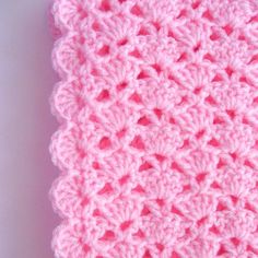 a pink crocheted dishcloth on a white surface