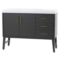 a bathroom vanity with two drawers and a white counter top that has gold handles on it