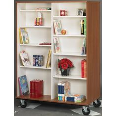 Take your books and reference materials anywhere on Stevens' Double-Side Mobile Bookshelf. It's a great choice for libraries, classrooms or anywhere that requires shared resources. The bookshelf moves easily on swivel casters (two locking). Adjust the shelves on both sides of the bookshelf to create 16 total book compartments. The bookshelf is made of durable particleboard and comes with a scratch-resistant laminate finish in your choice of color. Stevens' 67"H Double-Side Mobile Bookcase is mad Mobile Bookshelf, Book Carts, Diaper Storage, Book Cart, Cube Unit, Library Bookcase, Cube Bookcase, Office Bookcase, Solid Wood Shelves