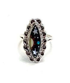 (Guaranteed 100% Sterling Silver) High quality 925 sterling silver size ring with natural genuine multicolor stones. The ring is handcrafted and the stones are inlaid together to create this beautiful Southwestern night themed piece of art jewelry. The stones consist of natural  Black Onyx, Mother of Pearl and Fire opal. The top of the ring measures 7/8'' x 1/2''. Our silver is genuine 925 sterling silver. You will receive the item in a gift box. Thanks for looking and check out more items in my Silver Oval Enamel Ring In Sterling Silver, Unique Black Crystal Ring In Sterling Silver, Oval Silver Enamel Ring In Sterling Silver, Black Jewelry With Inlay For Gift, Black Inlay Jewelry As A Gift, Multicolor Collectible Ring Jewelry, Adjustable Inlay Jewelry Ring, Black Ring With Inlay, Black Rings With Inlay