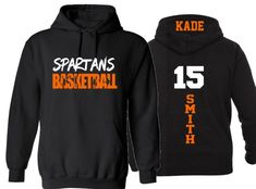 two black sweatshirts with orange and white numbers on them, one is for the basketball team