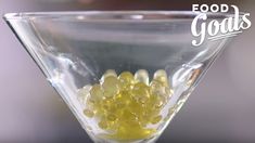 a martini glass filled with yellow gummy bears