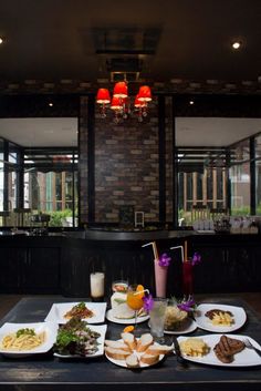 a table topped with plates of food and drinks