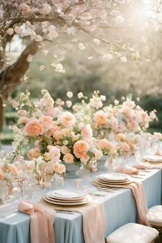 the table is set with flowers and place settings