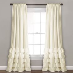 a white curtain with tiered ruffles in front of a window